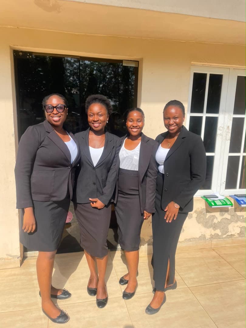 Four women law students dressed in black legal attire