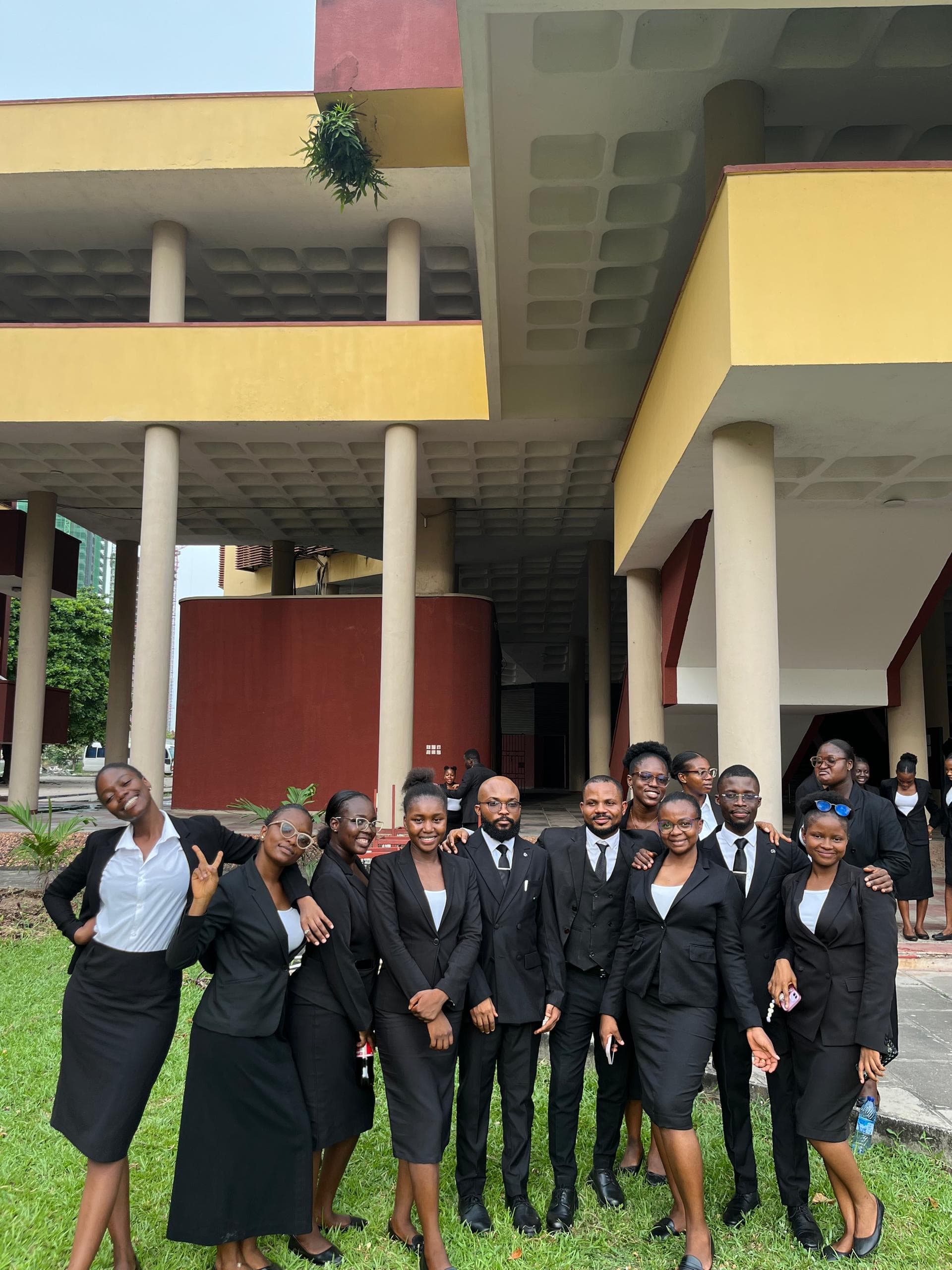 Law students dressed for legal training outside their university